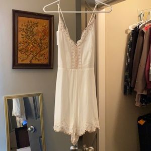 White romper with some embroidery.